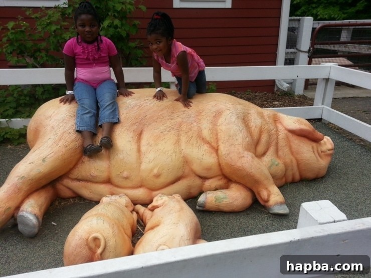 Minnesota Zoo Adventure 12 Two girls sitting on fake pig statues