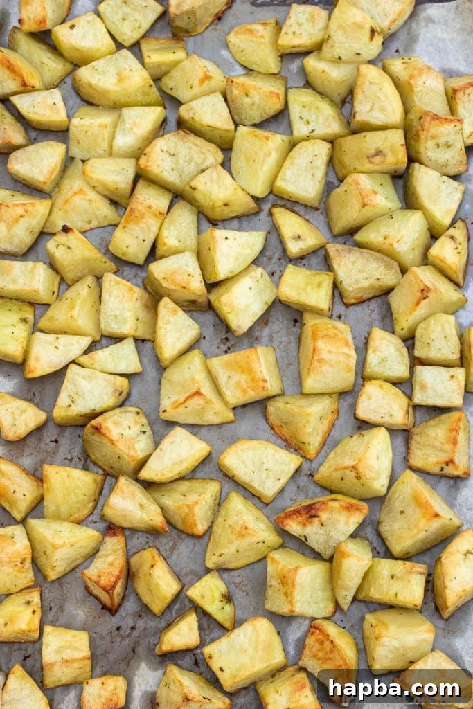 Crispy Oven Potatoes 4 easy roasted potatoes on baking sheet lined with parchment paper