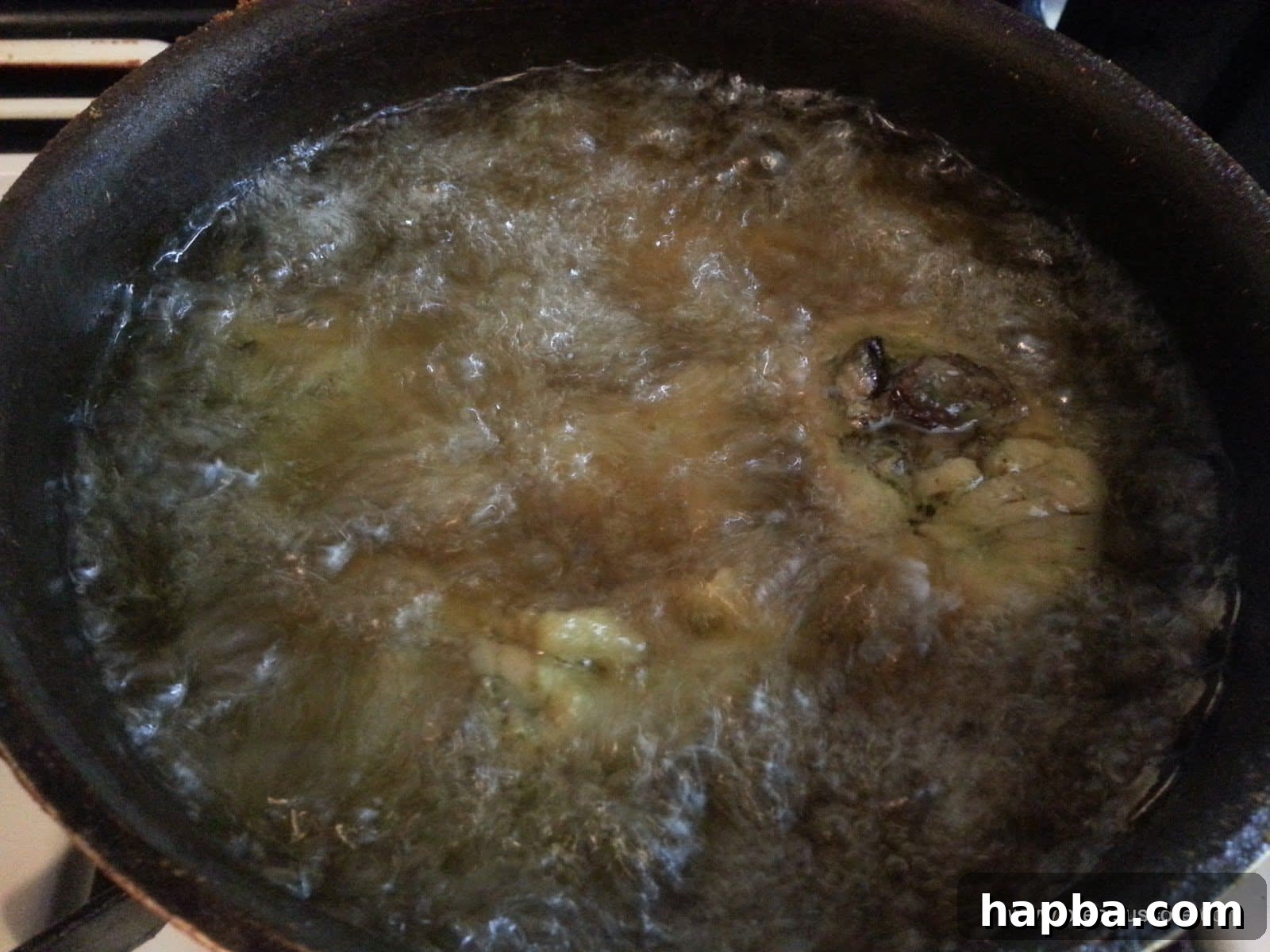 Frying Chicken to Golden Perfection Chicken pieces frying in hot oil, turning golden brown and crispy