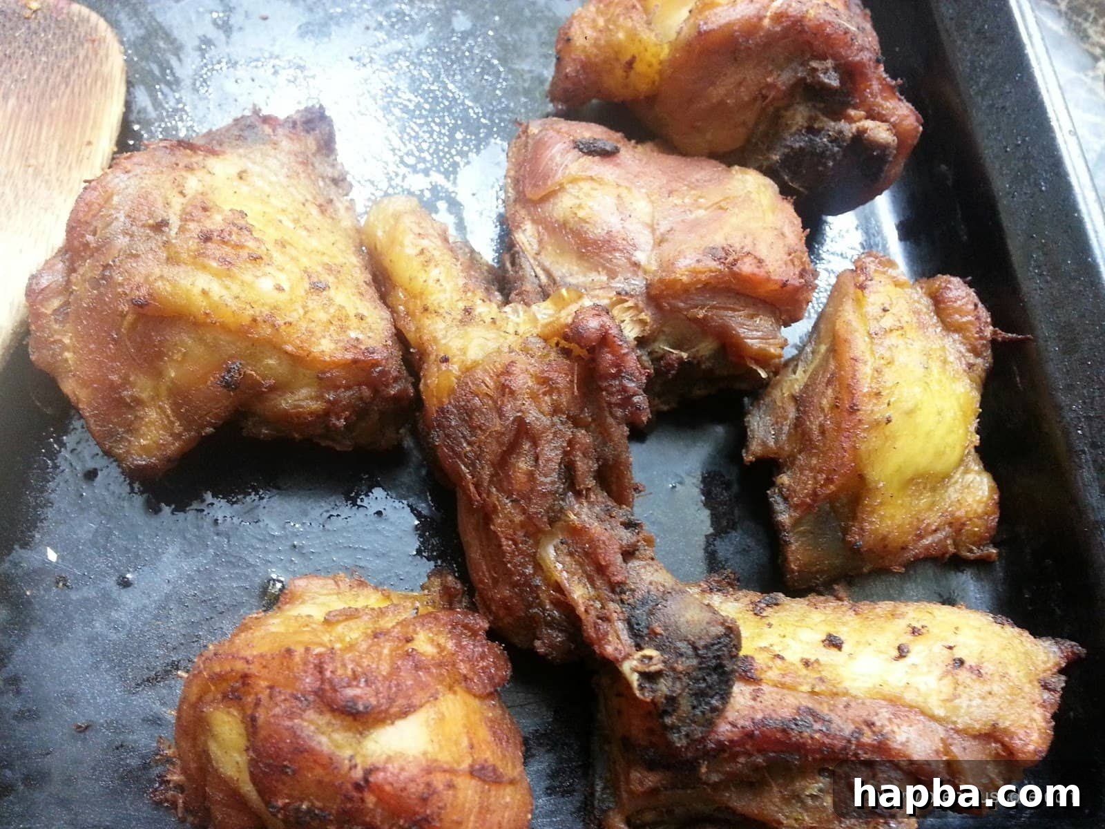 Served Plate of Authentic Cameroon Fried Chicken A plate piled high with perfectly fried, golden brown Cameroonian chicken, garnished and ready to be enjoyed