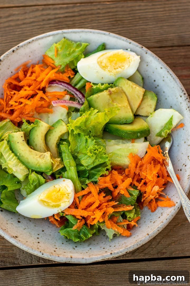 A delightful serving of fresh lettuce salad in a bowl, glistening with the zesty lemon dressing, ready to be enjoyed.