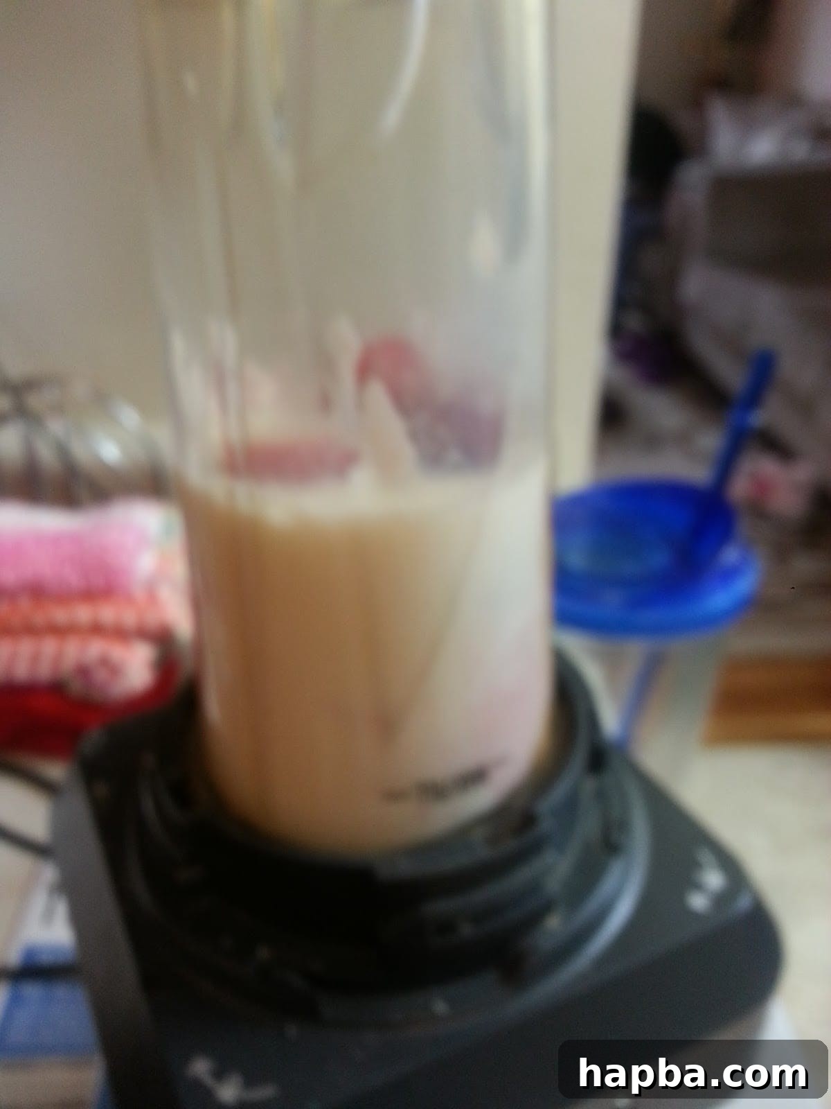Blending Fruit and Yogurt for Popsicles Ingredients in a blender ready to be mixed