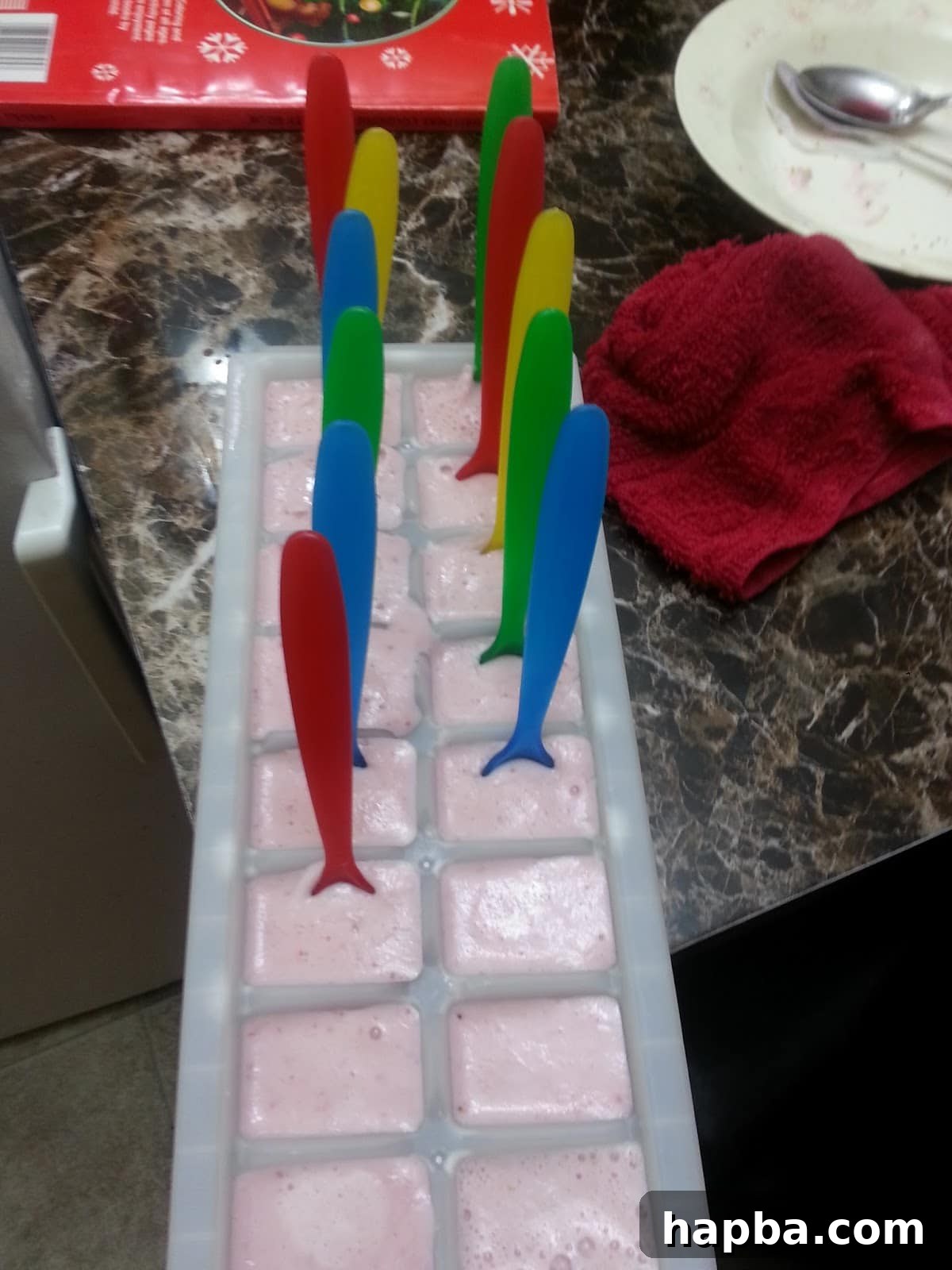 Inserting Sticks into Yogurt Popsicles Popsicle sticks inserted into partially frozen popsicles