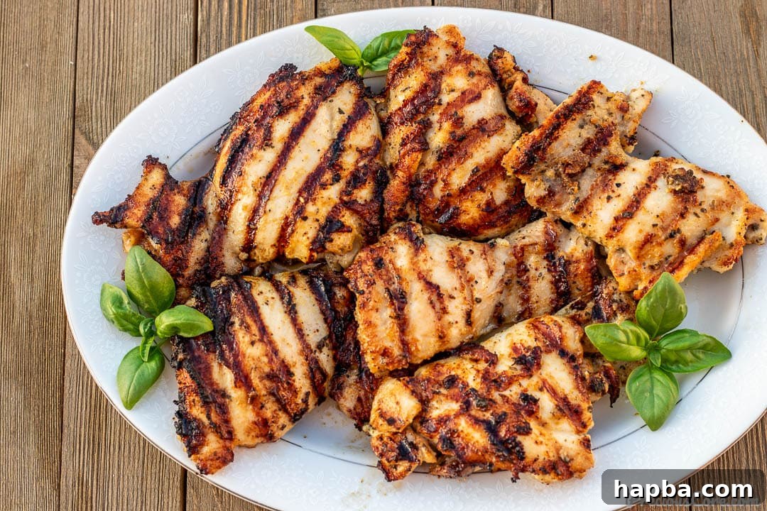 Platter of perfectly grilled chicken thighs with a charred finish