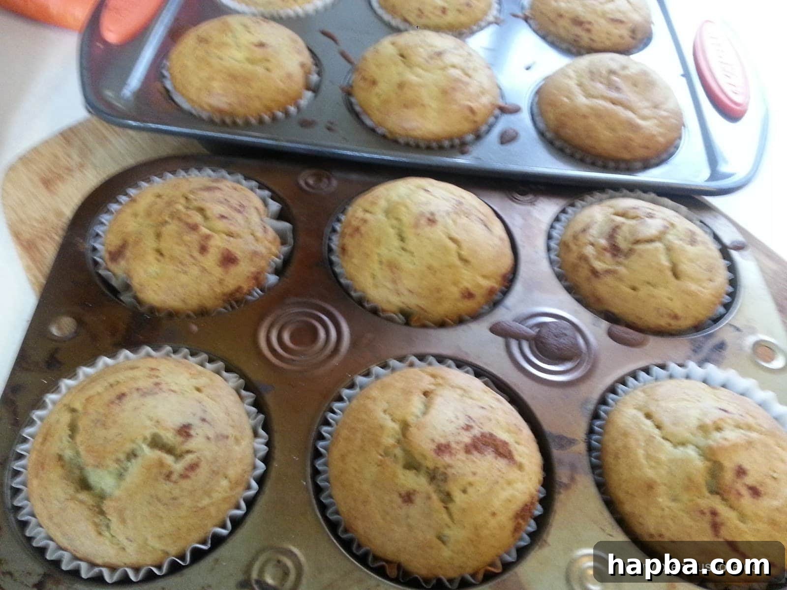 Freshly baked Cameroonian banana cakes in muffin pans, golden brown and puffed up, straight from the oven.