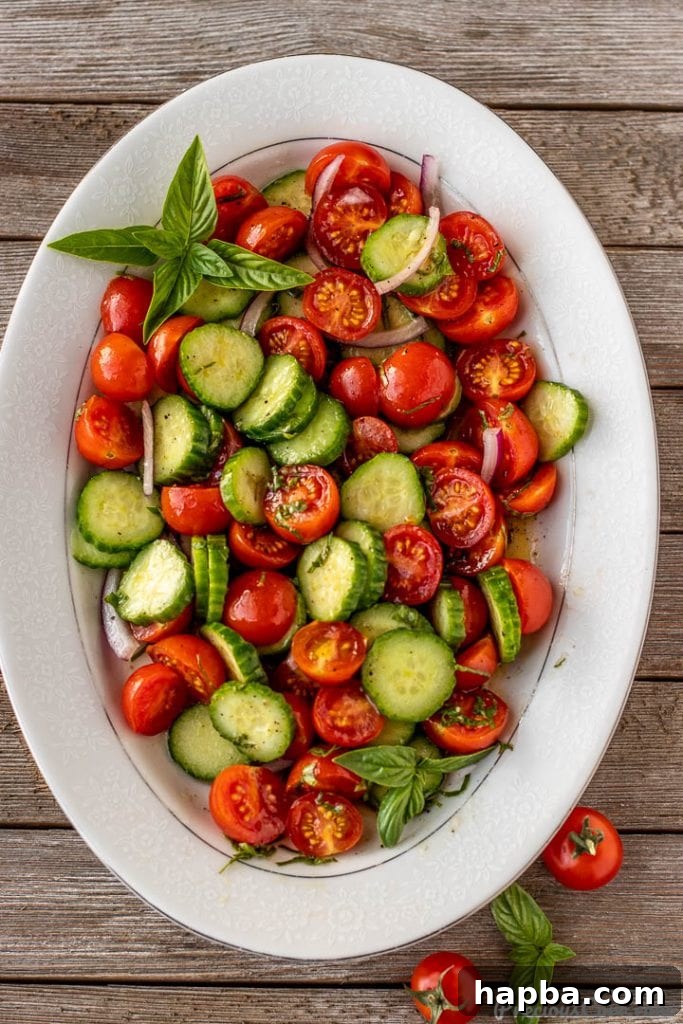 Vibrant Cucumber, Tomato, and Onion Medley 7 A close-up of the tossed cucumber tomato onion salad, ready to be served.