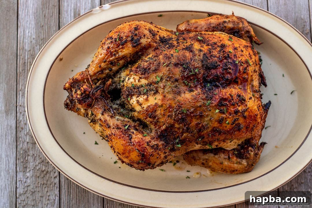Succulent Herb Roasted Chicken 8 A beautifully presented whole roast chicken on a platter, ready to be carved and served for a family meal.