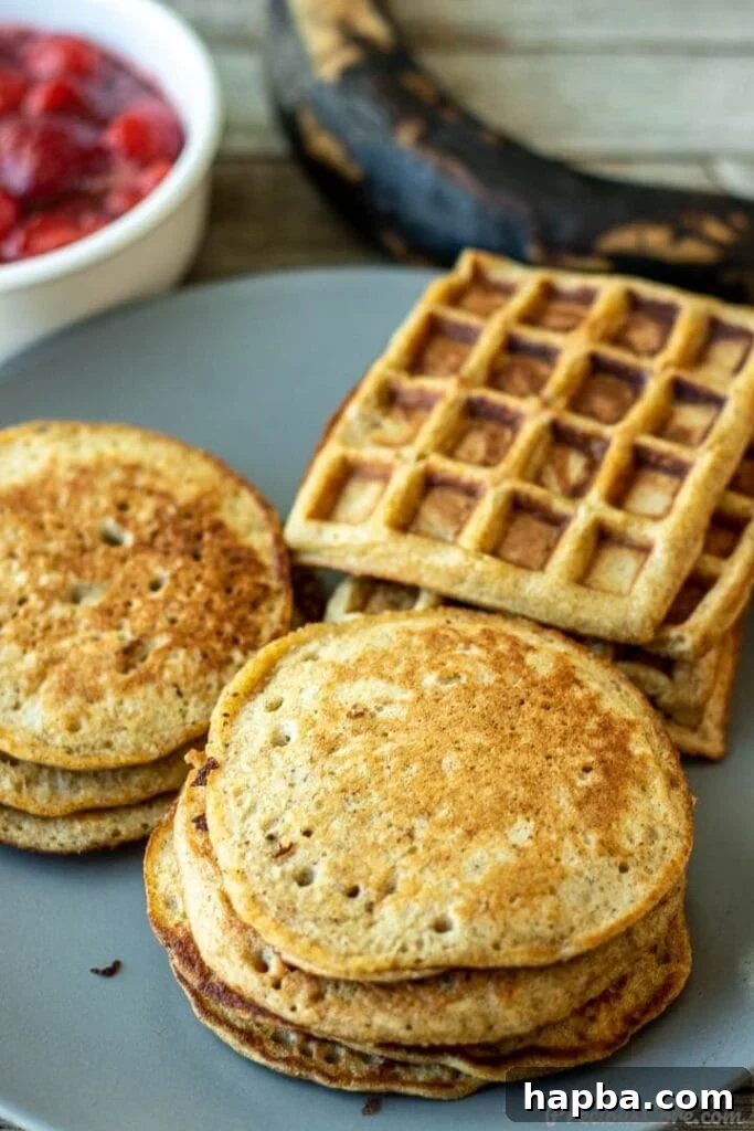 Golden brown plantain pancakes and waffles on a serving plate, drizzled with syrup