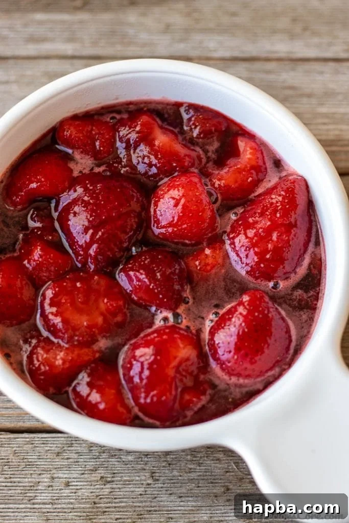 Freshly made strawberry sauce in a white bowl, perfect for topping pancakes