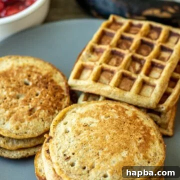 Golden brown plantain pancakes and waffles on a serving plate, drizzled with syrup