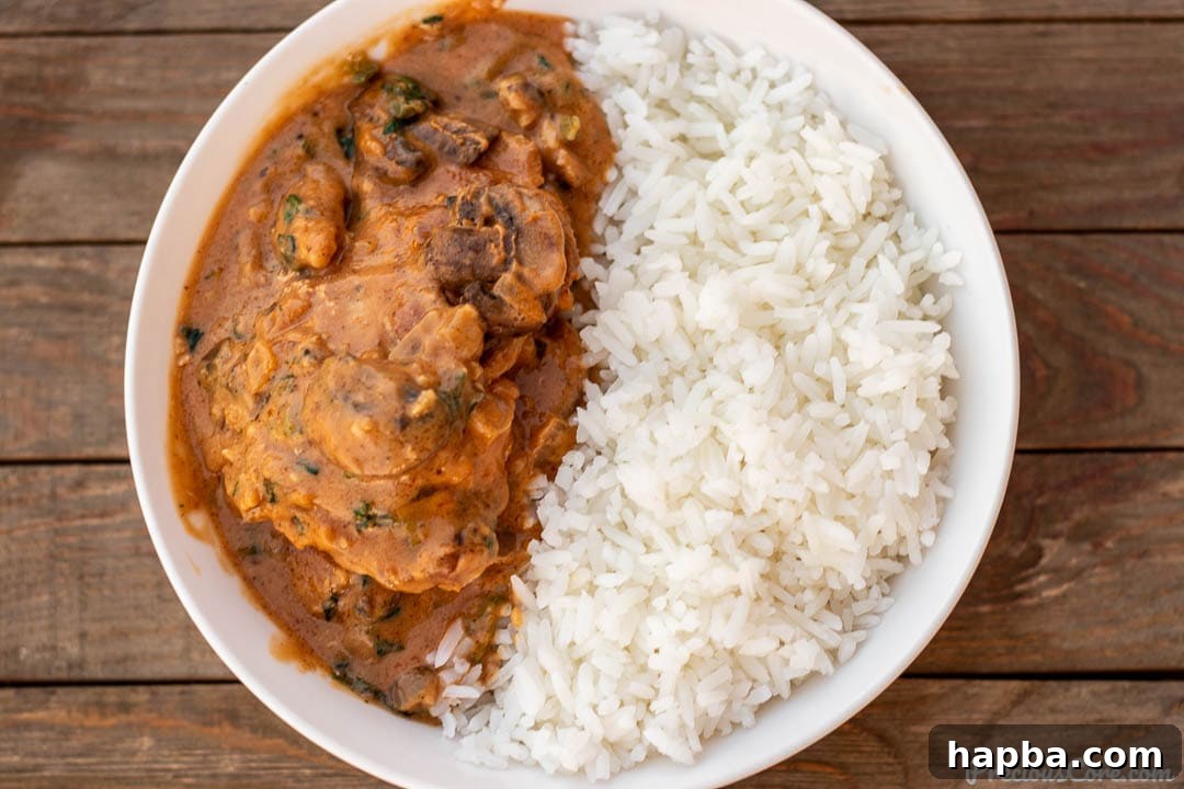 West African Groundnut Chicken Stew 3 Landscape picture of chicken peanut stew and rice, ready to be enjoyed.