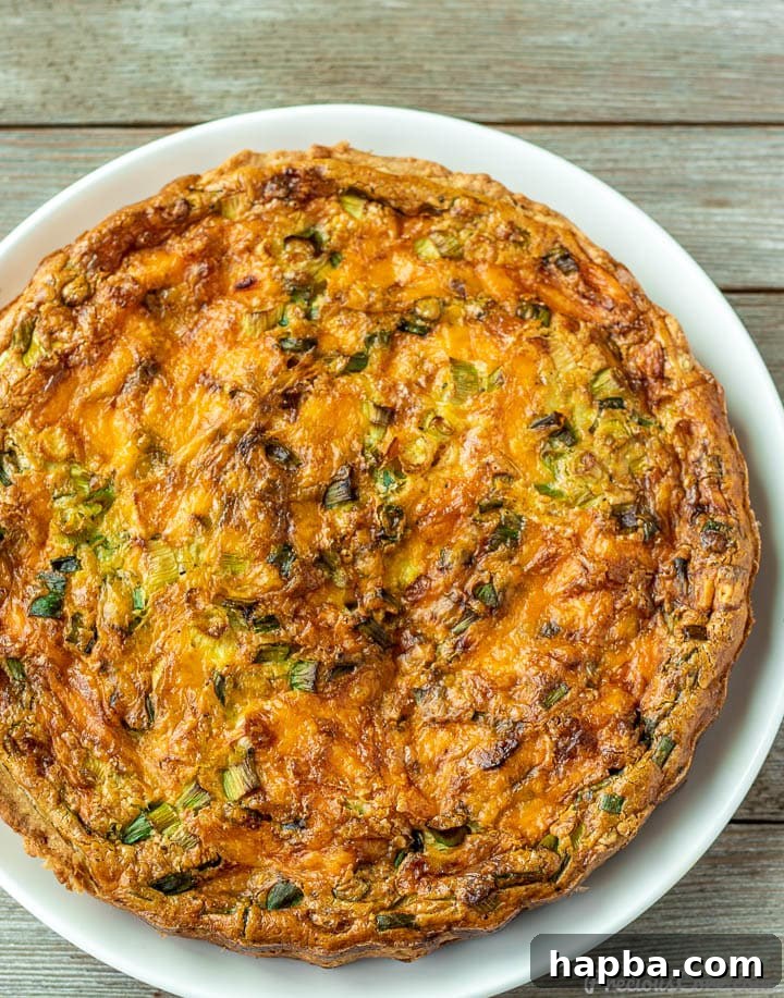 Effortless Quiche Delight 3 A close-up of a slice of easy quiche on a plate, highlighting the creamy filling and flaky crust.
