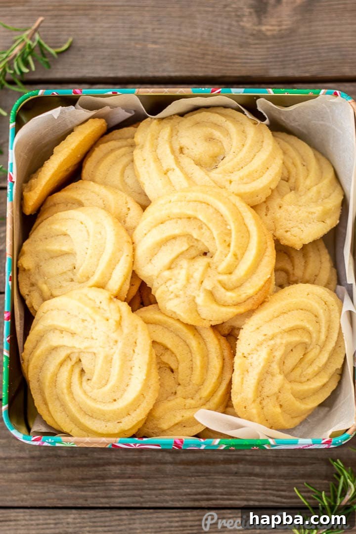 A festive cookie tin filled with a variety of Danish Butter Cookies, ready for gifting.
