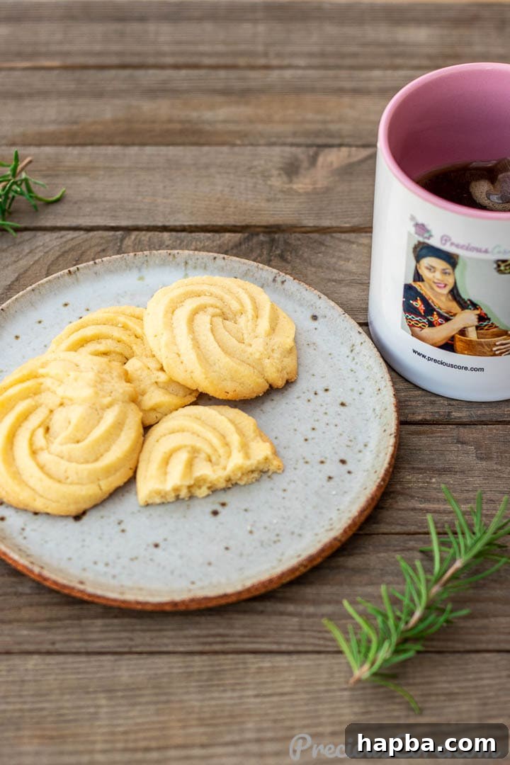 A cozy shot of Danish Butter Cookies served with a cup of tea, emphasizing comfort and enjoyment.