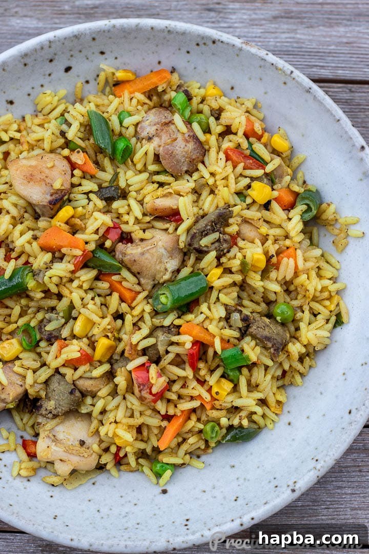 Close-up of a serving bowl filled with African Fried Rice, showcasing its rich colors and ingredients