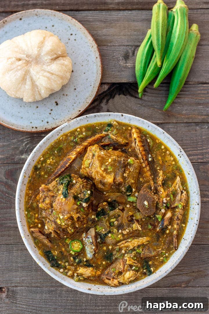 Vibrant African Okra Soup 2 A bowl of African Okra Soup with a plate of Garri fufu on the side, ready to be enjoyed.