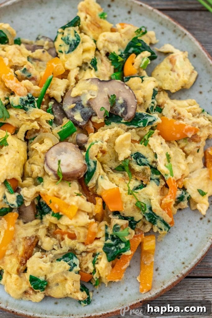 Colorful Morning Scramble 3 A close-up view revealing the fluffy texture and colorful mix of scrambled eggs with vegetables.