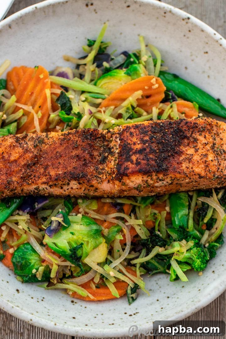 Golden Pan Seared Salmon 3 A vibrant plate featuring tender pan-grilled salmon alongside fresh, colorful vegetables.