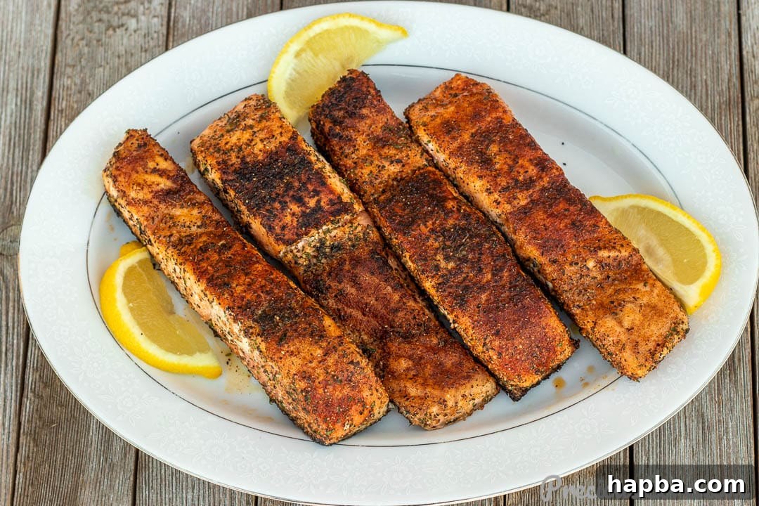 Golden Pan Seared Salmon 6 A close-up landscape shot of perfectly seasoned, uncooked salmon fillets, ready for pan grilling.