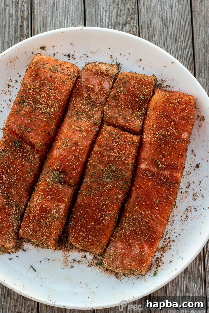 Golden Pan Seared Salmon 7 Close-up of salmon fillets thoroughly coated with a flavorful seasoning rub, ready for the pan.