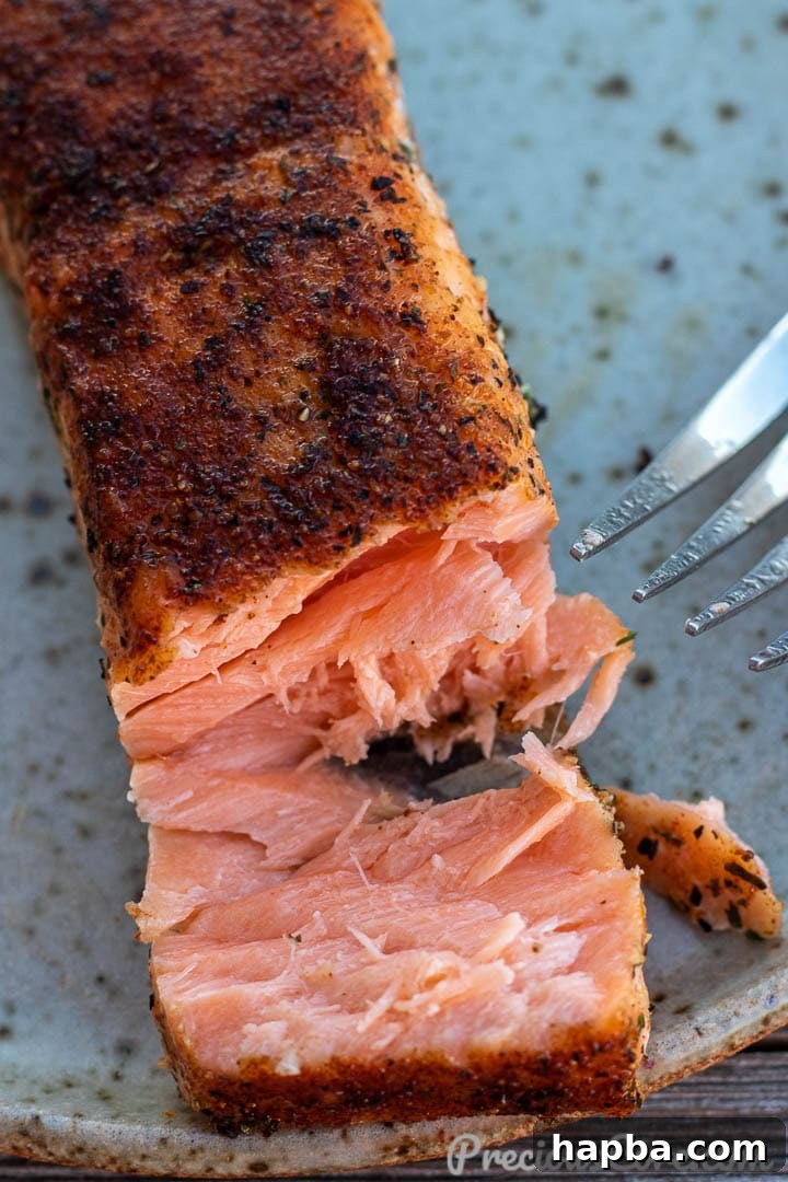 Golden Pan Seared Salmon 9 A close-up of a perfectly cooked, juicy pan-grilled salmon fillet, showing its tender, flaky texture.
