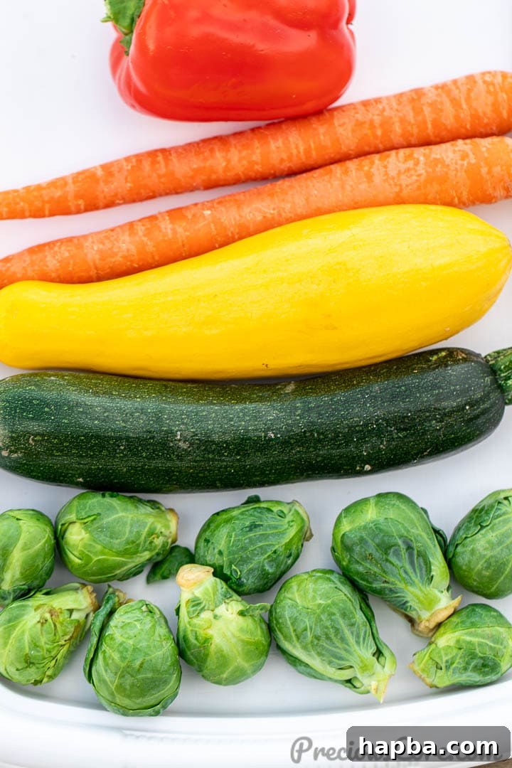 A vibrant selection of different fresh vegetables neatly arranged on a tray, ready for preparation.