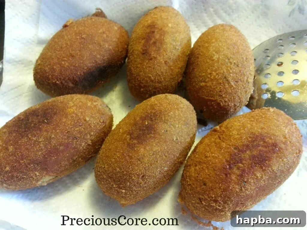 A complete batch of golden brown fish Scotch Eggs, ready to be served