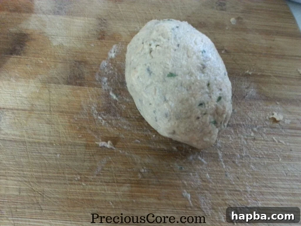 Fish mixture carefully molded around a hard-boiled egg