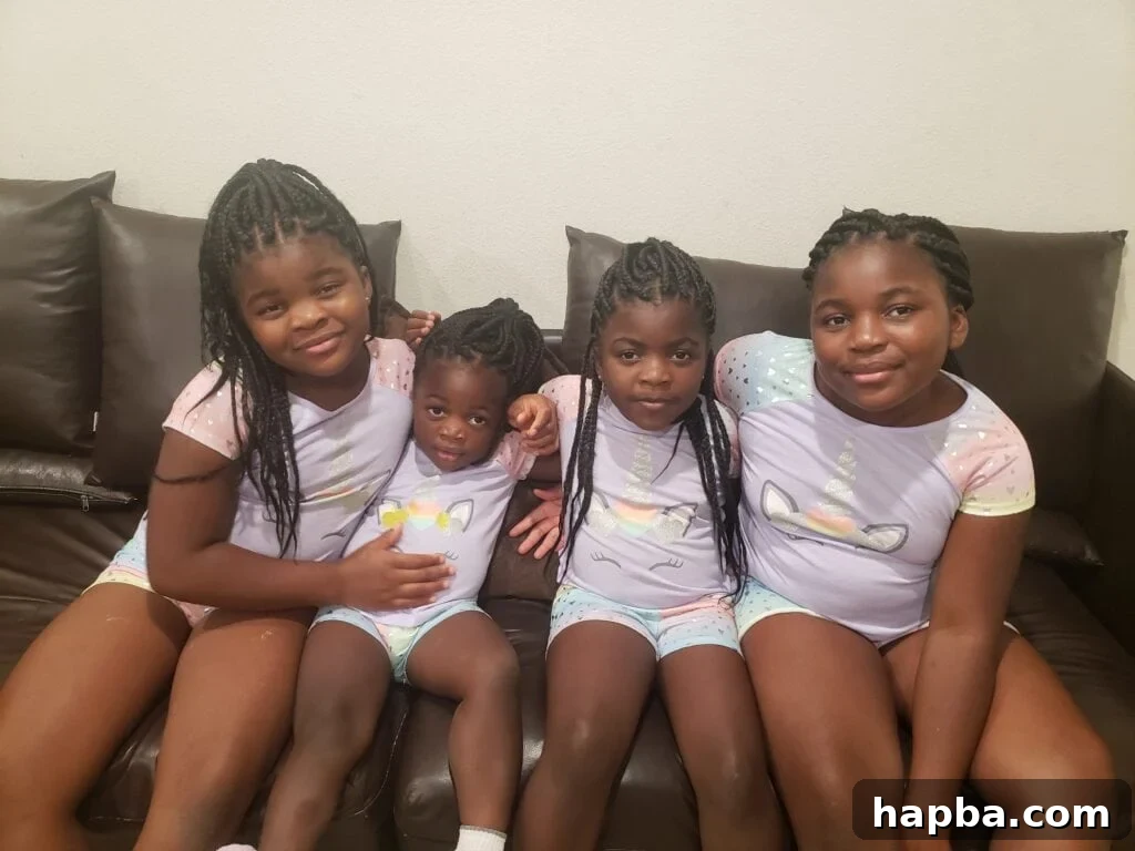 4 brown girls sitting on couch.
