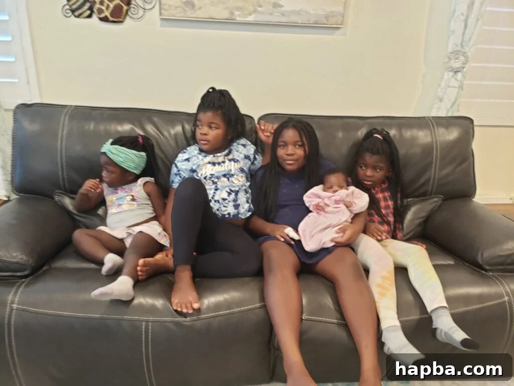 Five girls sitting on couch.
