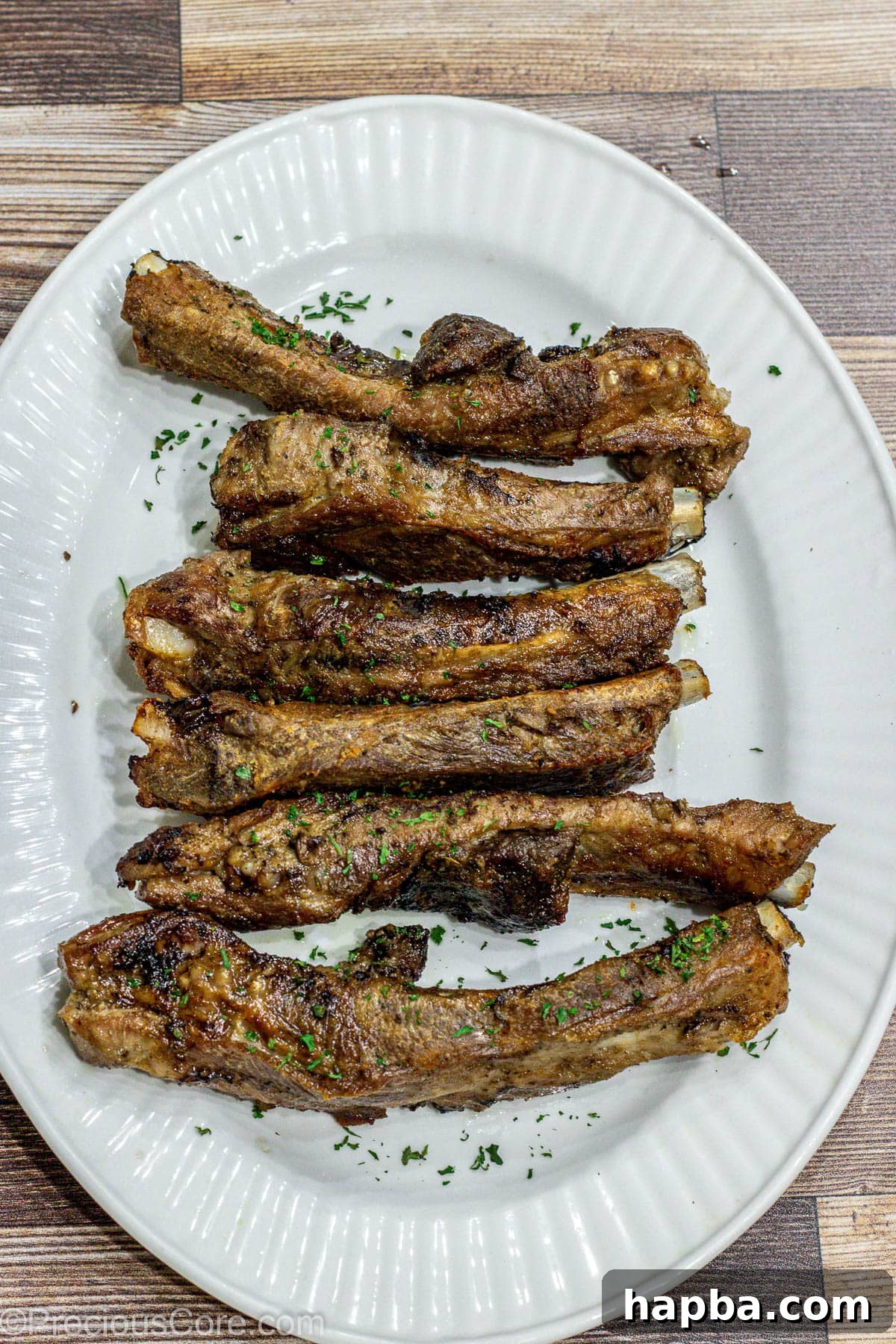 Tender Dry-Rubbed Ribs 8 Perfectly cooked, tender dry rub ribs beautifully arranged on a rustic serving tray, ready for a feast.