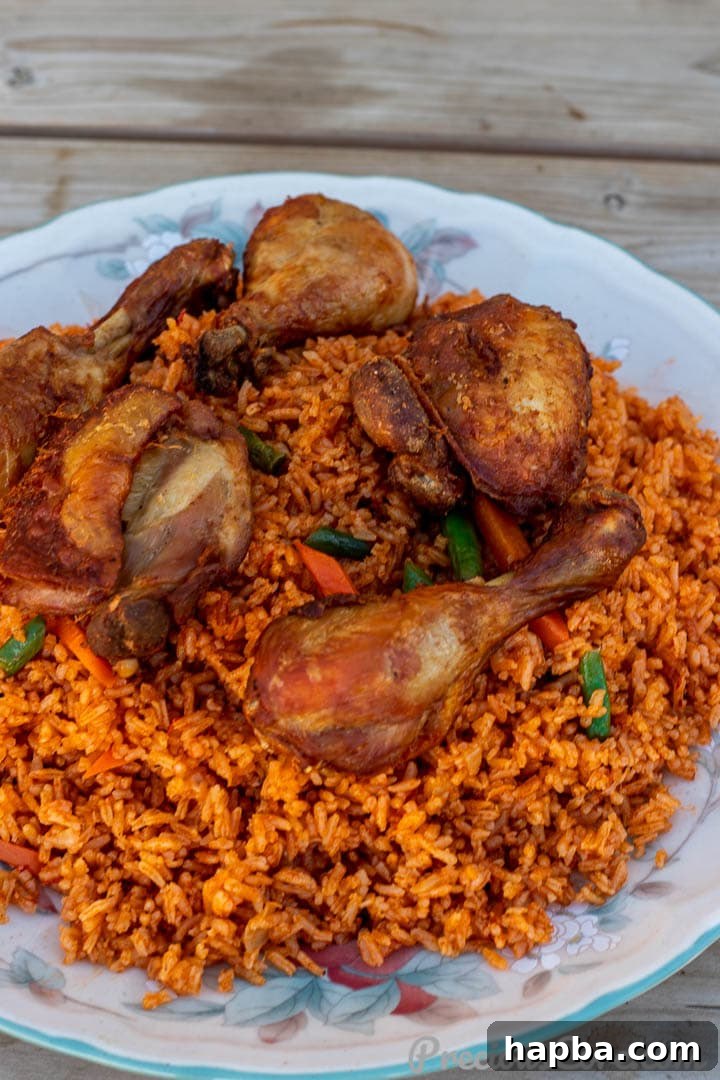Shot at another angle jollof rice with chicken on a platter