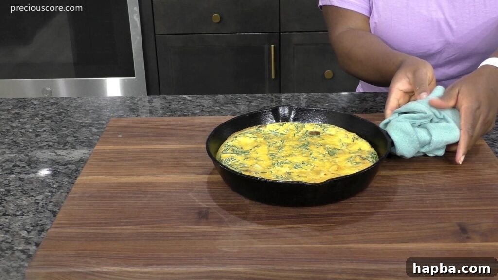 Hearty Potato Egg Bake 11 A baked Potato Frittata, golden and puffed, removed from the oven, showcasing its perfectly cooked state.