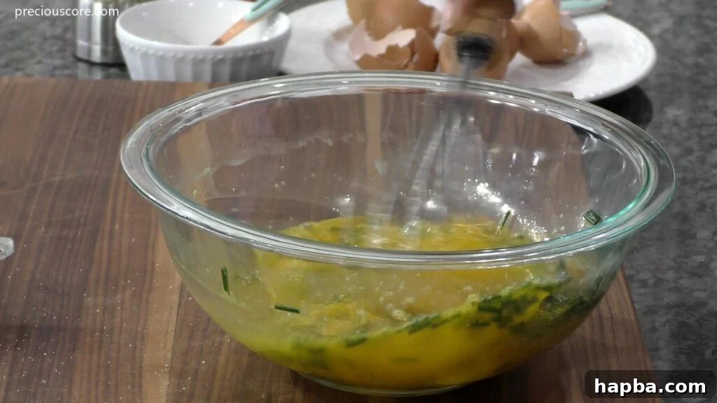 Hearty Potato Egg Bake 8 A bowl of whisked egg mixture, infused with herbs and seasonings, ready for the frittata.