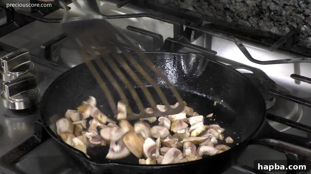 Hearty Potato Egg Bake 9 Sliced mushrooms sautéing in a hot skillet, turning golden brown and tender.
