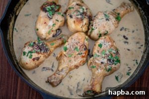 Close-up of the luxurious creamy chicken sauce simmering in a skillet, nearly ready.