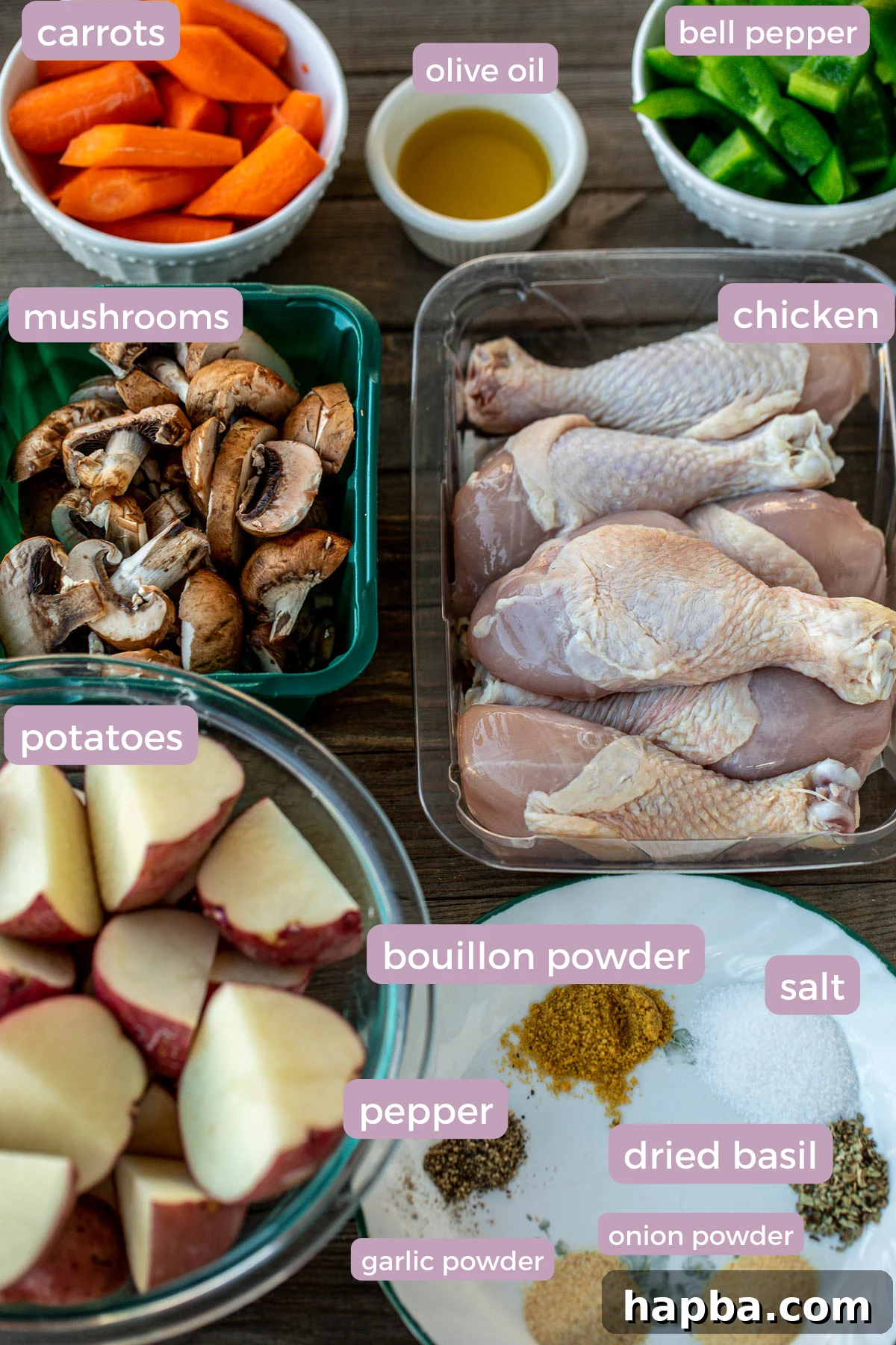 One Pan Golden Roasted Chicken and Vegetables 4 Fresh ingredients laid out on a kitchen counter, including red potatoes, olive oil, carrots, bell peppers, chicken drumsticks, and various seasonings, ready for a sheet pan meal.