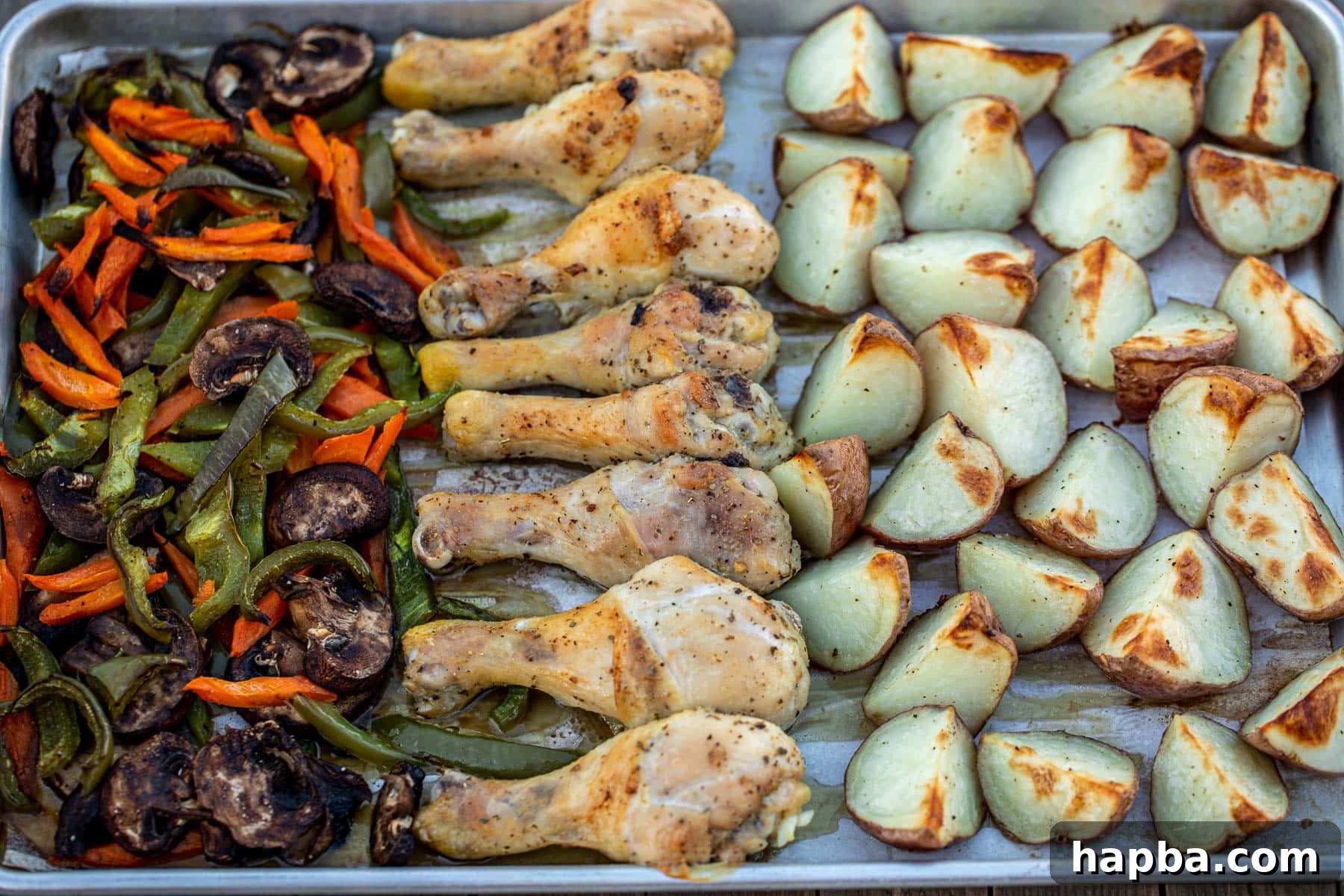 One Pan Golden Roasted Chicken and Vegetables 6 A panoramic shot of a golden-brown roasted chicken, tender potatoes, and vibrant mixed vegetables fresh out of the oven, steam gently rising, highlighting a perfectly cooked sheet pan meal.