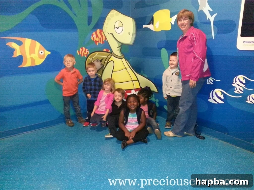 Girls with schoolmates and teacher at Sea Life Aquarium