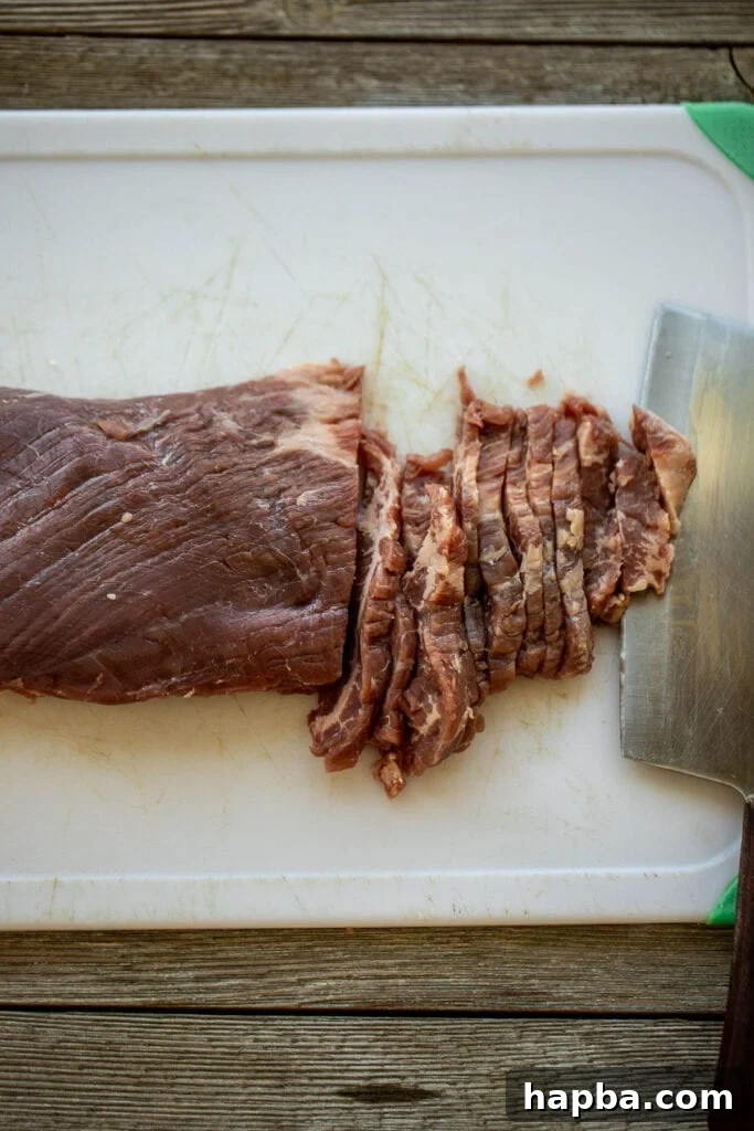 Beef on chopping board, showing how to cut against the grain