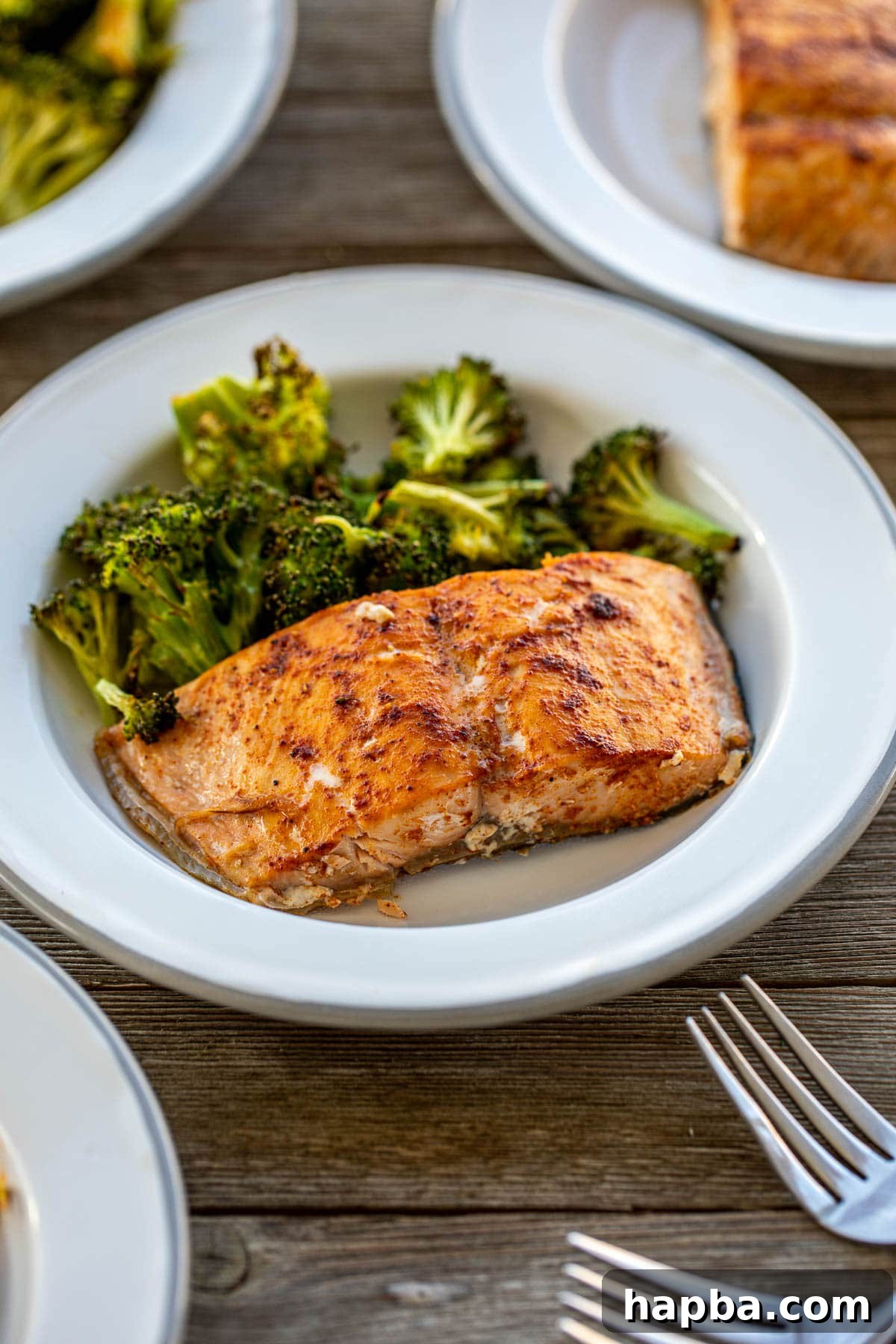 Effortless Sheet Pan Salmon and Broccoli 3 Plate with perfectly cooked salmon and roasted broccoli florets