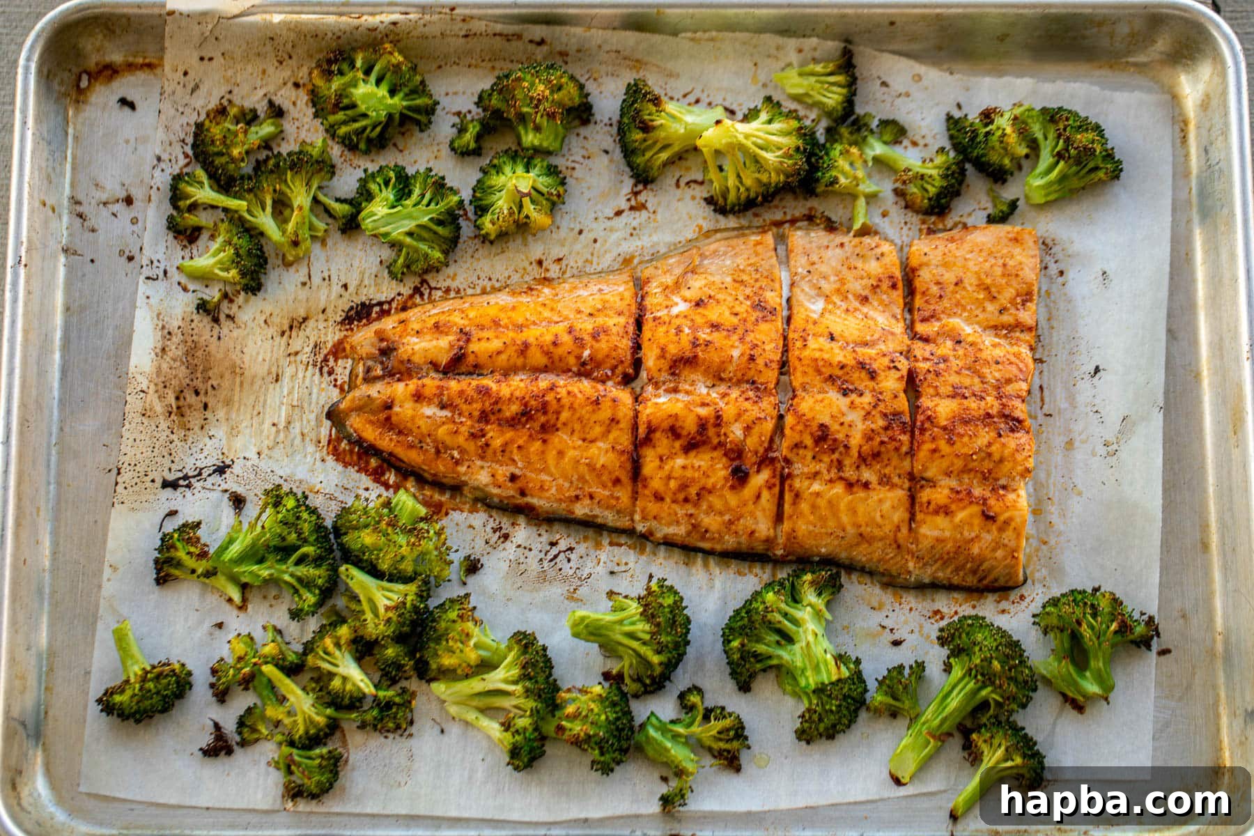 Effortless Sheet Pan Salmon and Broccoli 6 Landscape photo of baked salmon and broccoli, hot from the oven