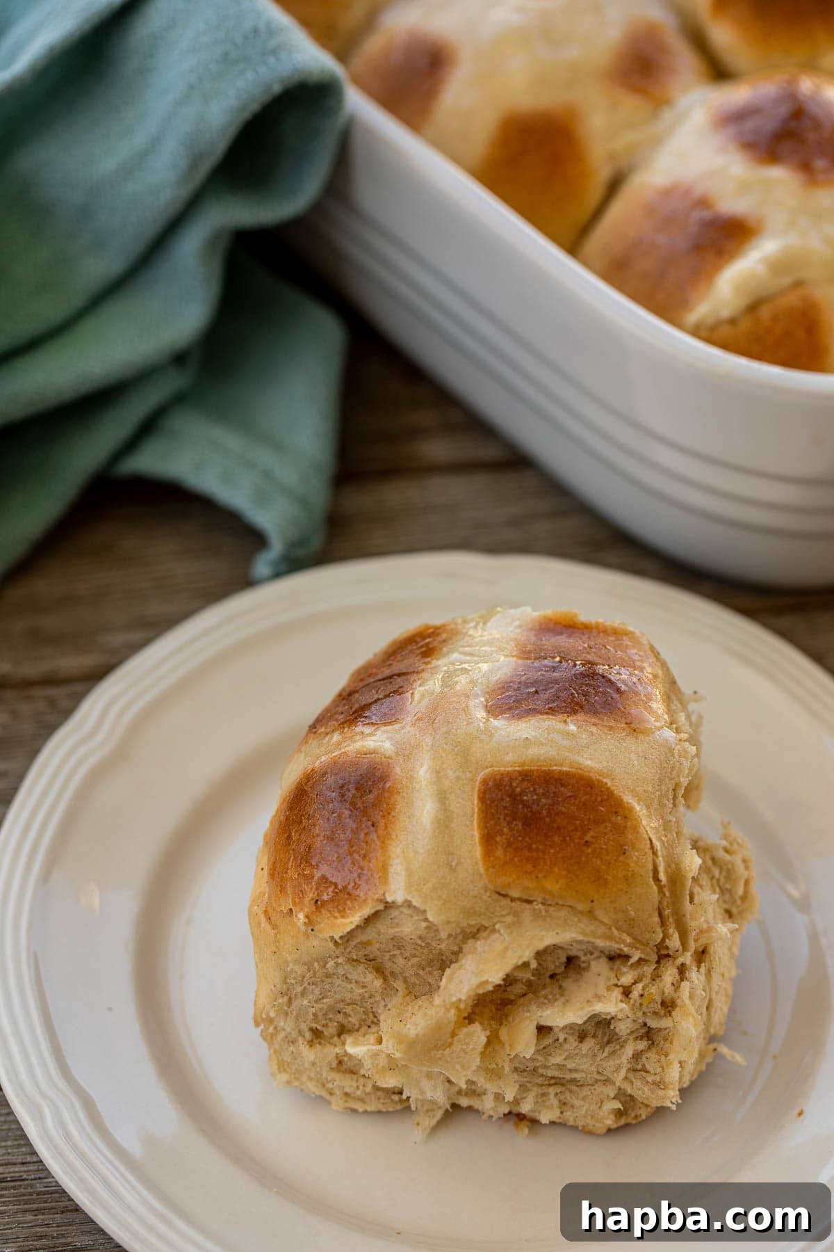 A sweet spiced bun on a plate 