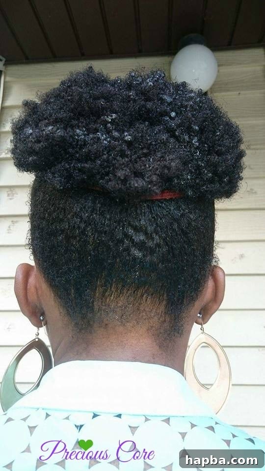 A close-up of a woman's styled natural hair, showing the intricate details of the mohawk.