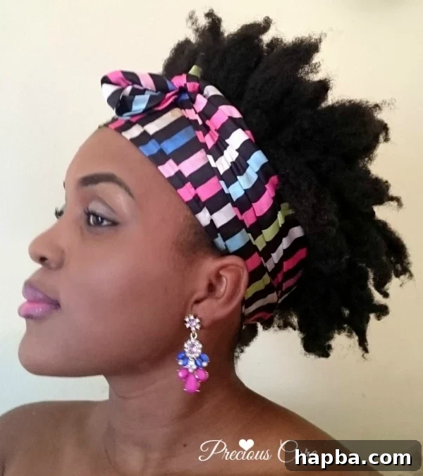 Another view of a woman with her natural hair in a bantu knot out, highlighting the texture.