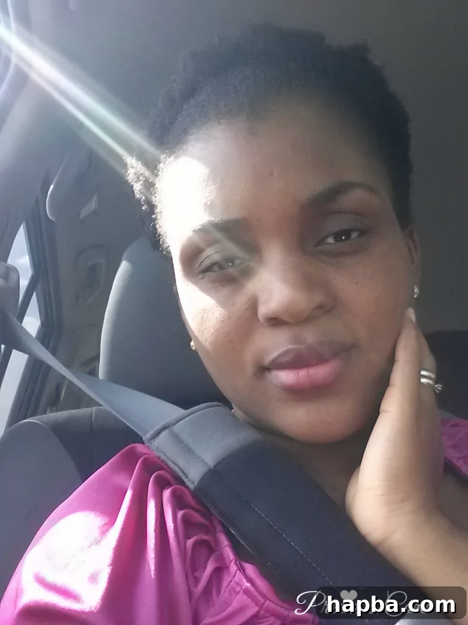 A woman proudly sporting a voluminous fro puff hairstyle.