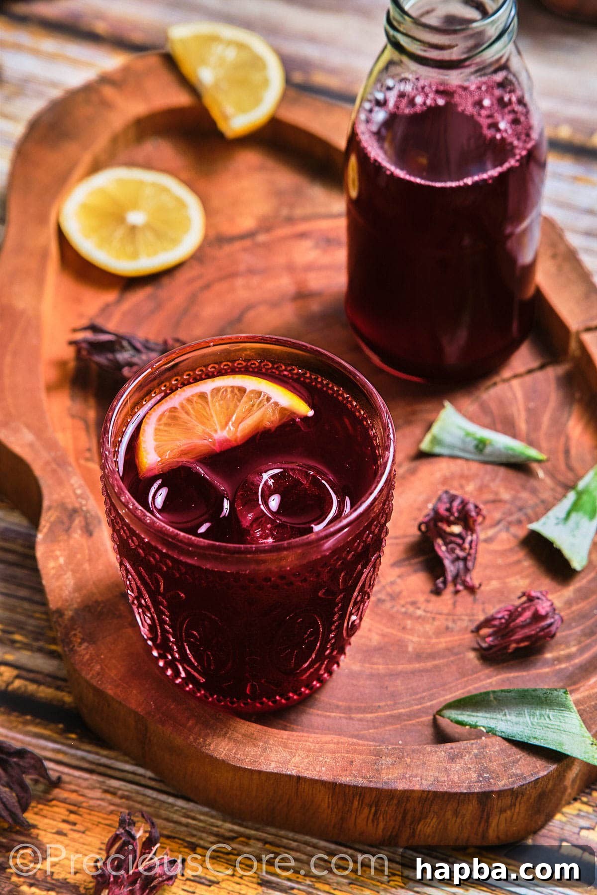 Folere Cameroonian Hibiscus Drink 3 A glass of Folere drink, brightly colored with a lemon wedge on the rim, ready to be enjoyed.