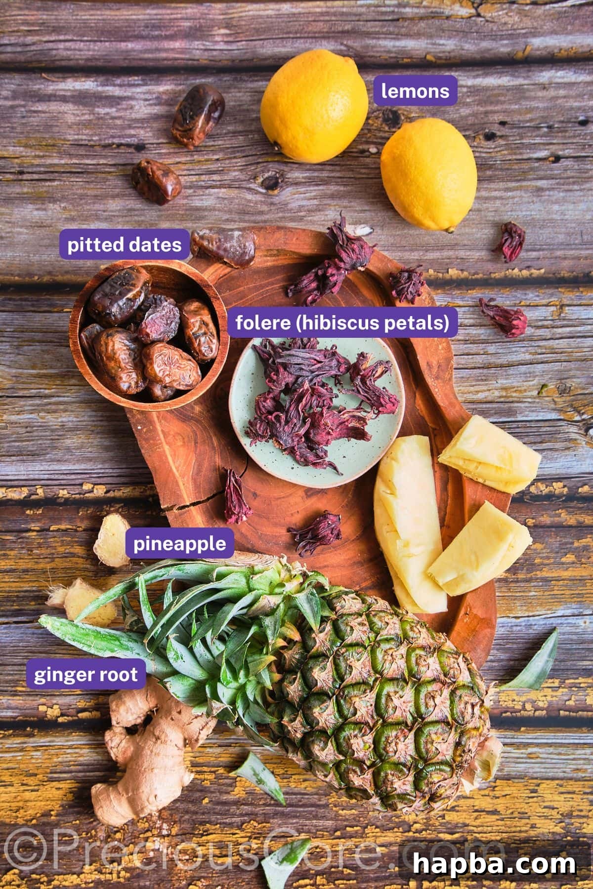 Folere Cameroonian Hibiscus Drink 4 Labeled ingredients for Folere Drink, showcasing dried hibiscus petals, pineapple, ginger, and dates.