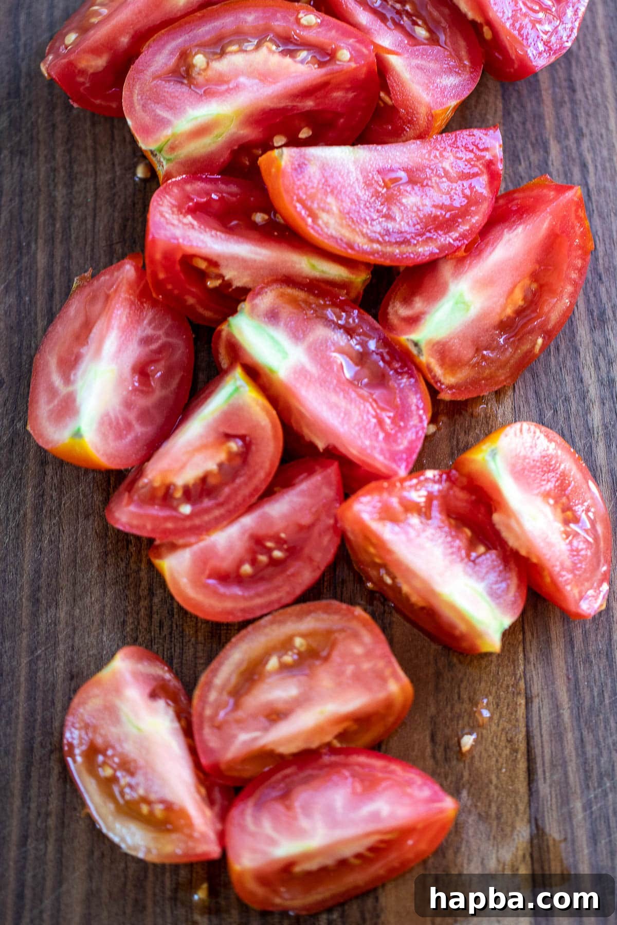 Artisan Homemade Tomato Paste 5 Freshly quartered tomatoes neatly arranged on a chopping board, ready for blending