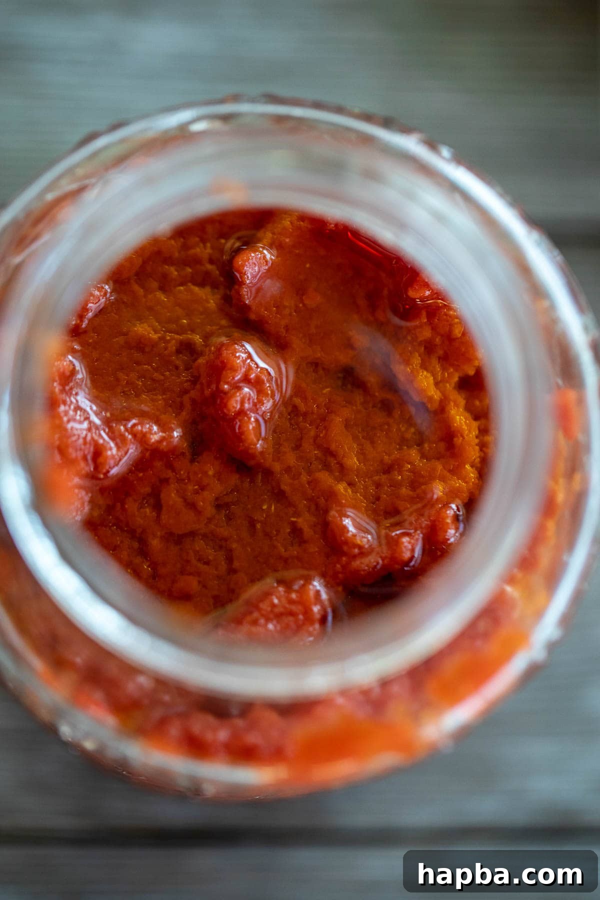 Artisan Homemade Tomato Paste 10 Homemade tomato paste stored in a mason jar with a layer of olive oil on top